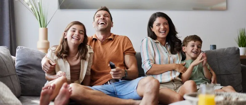 Cheerful family enjoying in a movie at home